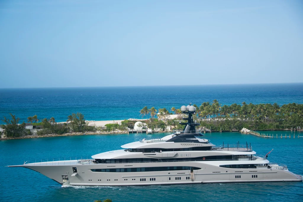 Superyacht cruising through turquoise water in The Bahamas on a winter yacht holiday