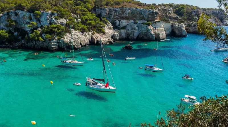 Cala de matressa in Menorca with crystal clear water and sailing boats