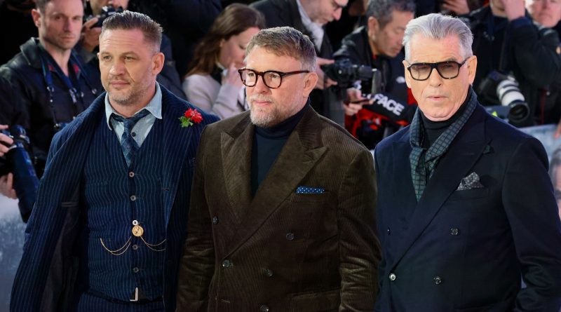 Alt Text: Tom Hardy Guy Ritchie and Pierce Brosnan at the MobLand London premiere