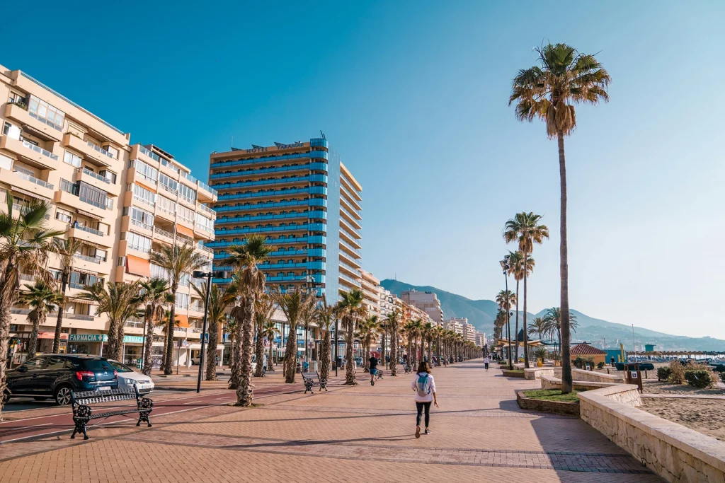 Fuengirola seafront promenade with palm trees, hotels and beach on the Costa del Sol.